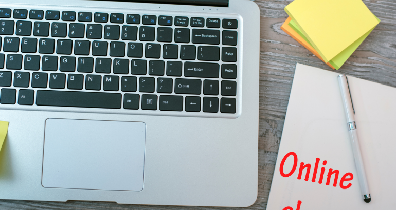 black desktop with green plant and red glasses - tablet with coronavirus news update screen